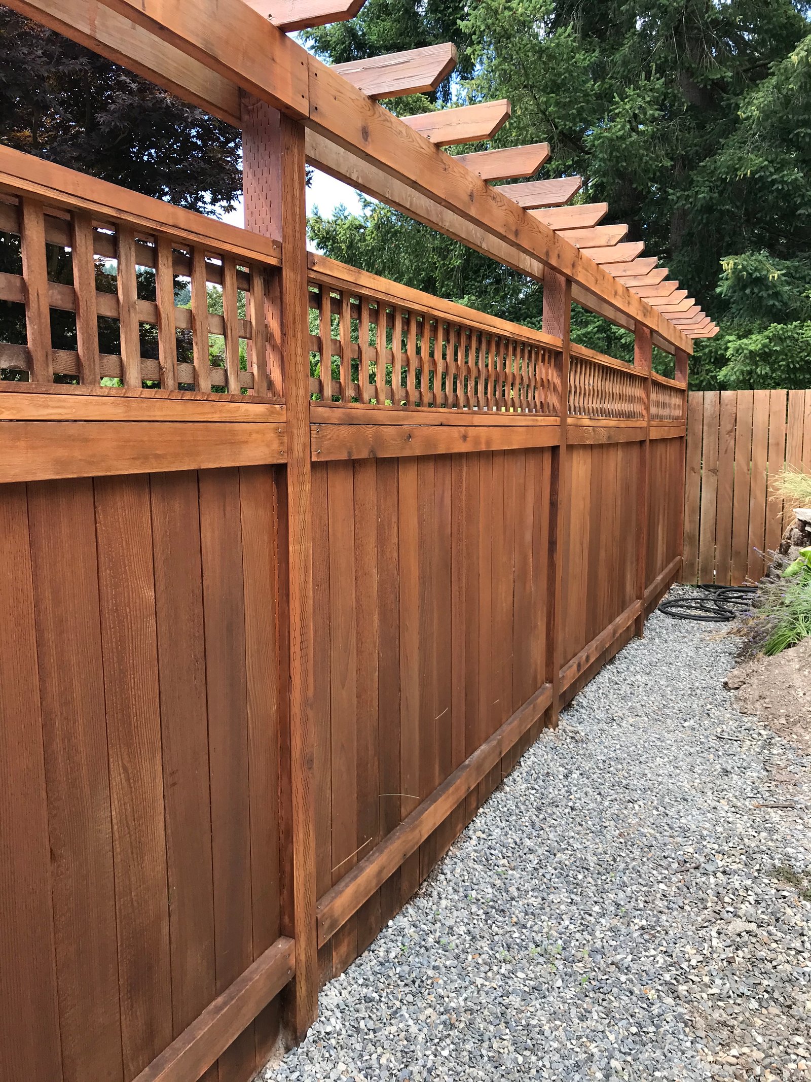 Wood fence that has been customized and stained in Eugene Oregon