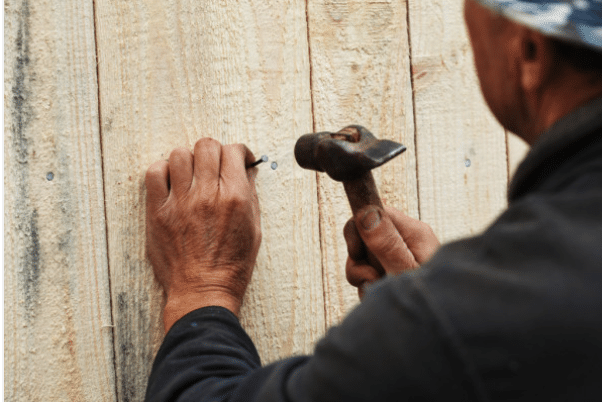 Wood fence being repaired by fence contractor in Eugene Oregon